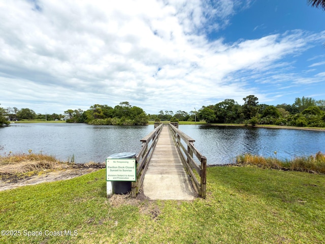 view of dock featuring a water view and a lawn