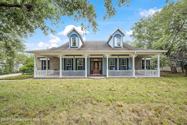 view of front of property featuring covered porch and a front yard