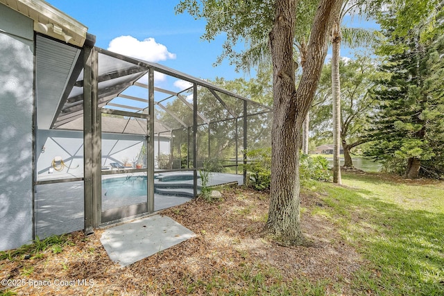 view of yard featuring a patio area, an outdoor pool, and a lanai
