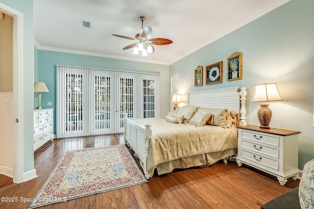 bedroom with visible vents, ornamental molding, ceiling fan, wood finished floors, and access to exterior