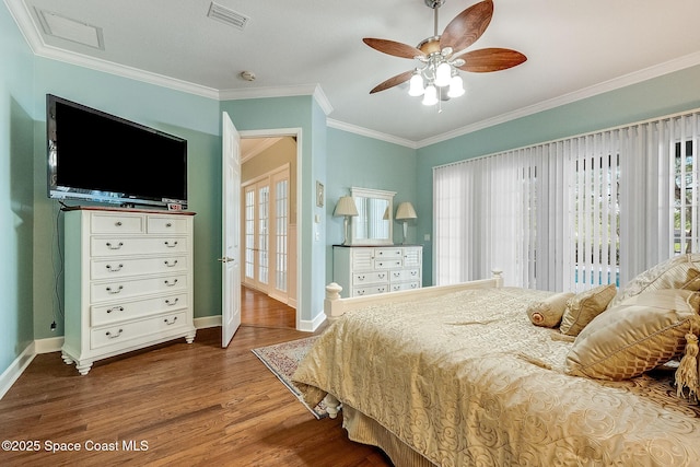 bedroom featuring baseboards, crown molding, visible vents, ceiling fan, and wood finished floors