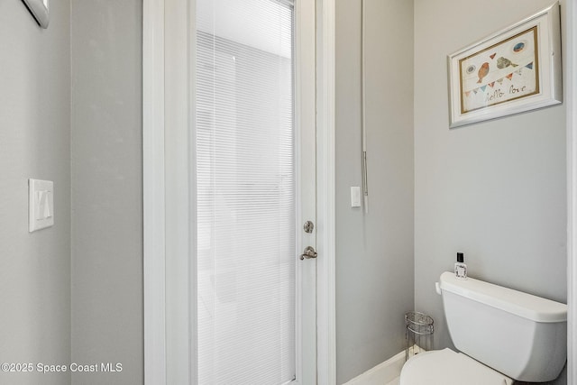 bathroom featuring toilet and a wall mounted air conditioner