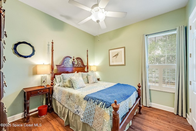 bedroom with baseboards, a ceiling fan, and wood finished floors