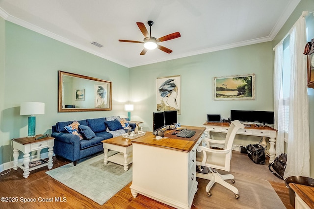 office area featuring wood finished floors, ornamental molding, a ceiling fan, and visible vents