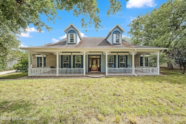 view of front of home with a porch, a front lawn, and brick siding