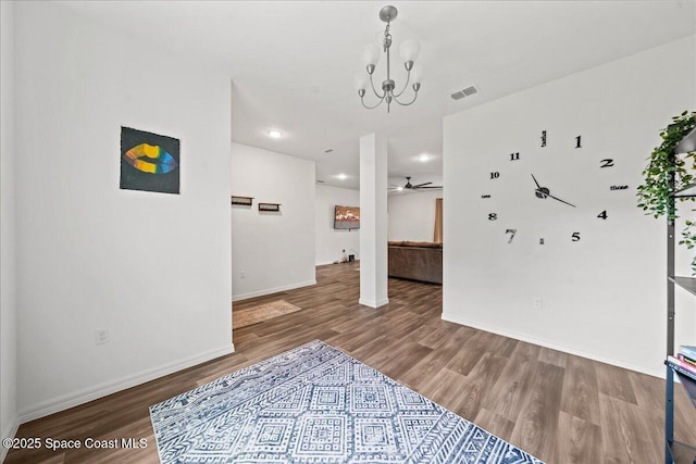 710 Mulberry St, Sebastian, FL 32958 - unfurnished room with ceiling fan with notable chandelier, visible vents, wood finished floors, and baseboards