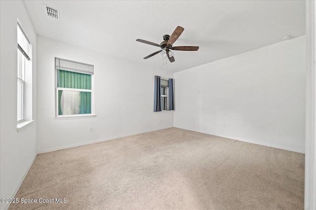 710 Mulberry St, Sebastian, FL 32958 - unfurnished room featuring carpet, visible vents, a wealth of natural light, and a ceiling fan