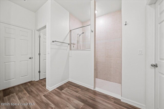 710 Mulberry St, Sebastian, FL 32958 - full bathroom featuring baseboards, a walk in shower, and wood finished floors