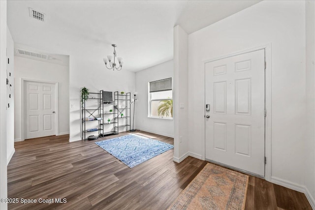 710 Mulberry St, Sebastian, FL 32958 - entryway with an inviting chandelier, visible vents, and wood finished floors