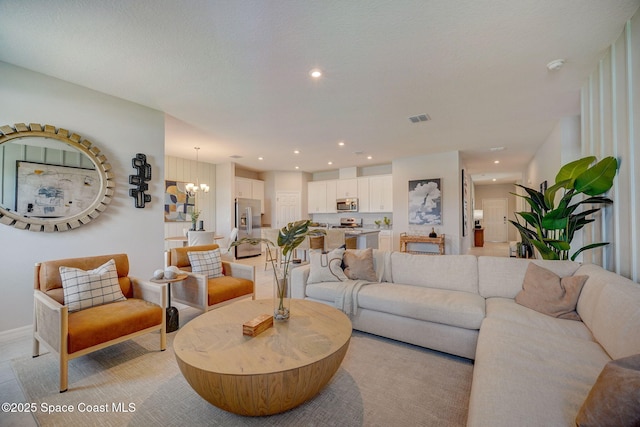 3150 Viridian Cir, Melbourne, FL 32904 - living room with visible vents, an inviting chandelier, and recessed lighting