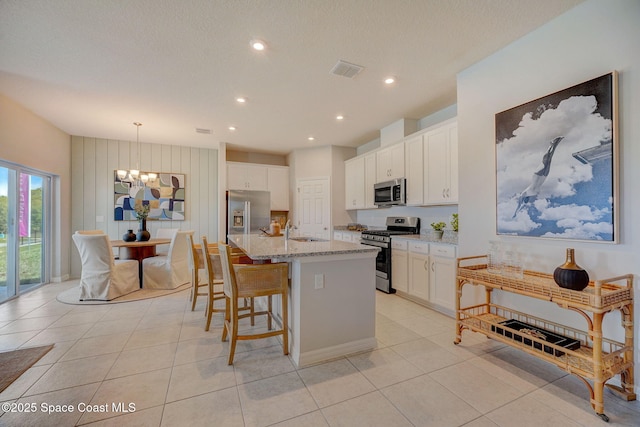 3150 Viridian Cir, Melbourne, FL 32904 - kitchen featuring an inviting chandelier, stainless steel appliances, white cabinetry, and visible vents