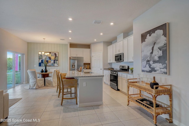 3150 Viridian Cir, Melbourne, FL 32904 - kitchen featuring light tile patterned flooring, visible vents, appliances with stainless steel finishes, and an inviting chandelier