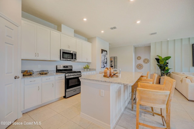 3150 Viridian Cir, Melbourne, FL 32904 - kitchen featuring visible vents, white cabinets, and appliances with stainless steel finishes