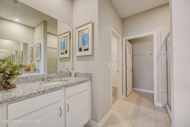 3150 Viridian Cir, Melbourne, FL 32904 - bathroom featuring a stall shower, vanity, tile patterned flooring, and a spacious closet