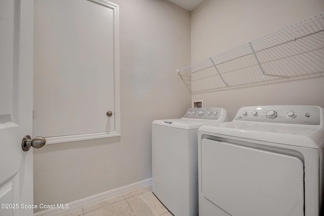 3150 Viridian Cir, Melbourne, FL 32904 - laundry room featuring light tile patterned flooring, washer and clothes dryer, baseboards, and laundry area