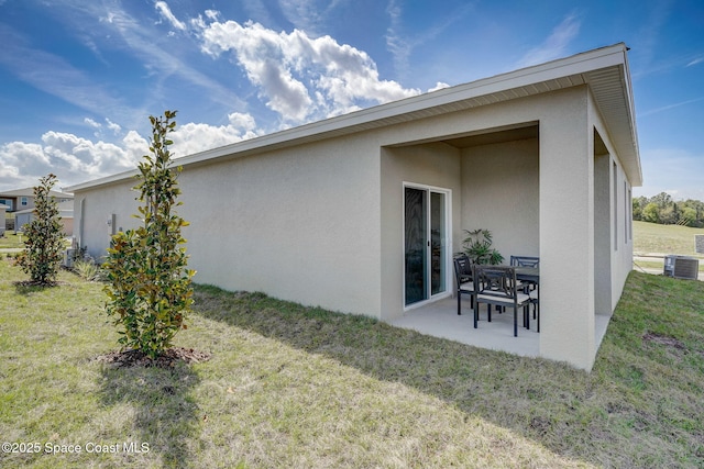 3150 Viridian Cir, Melbourne, FL 32904 - back of property featuring a yard, stucco siding, central air condition unit, and a patio area