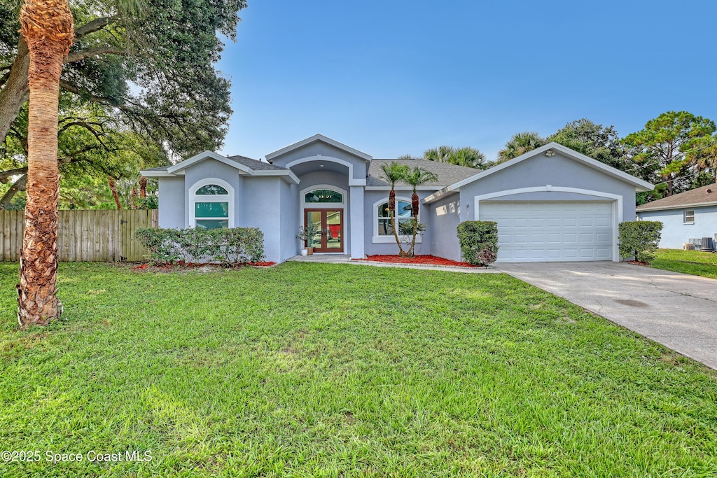 6135 Balboa St, Cocoa, FL 32927 - ranch-style home featuring french doors, stucco siding, a garage, driveway, and roof with shingles