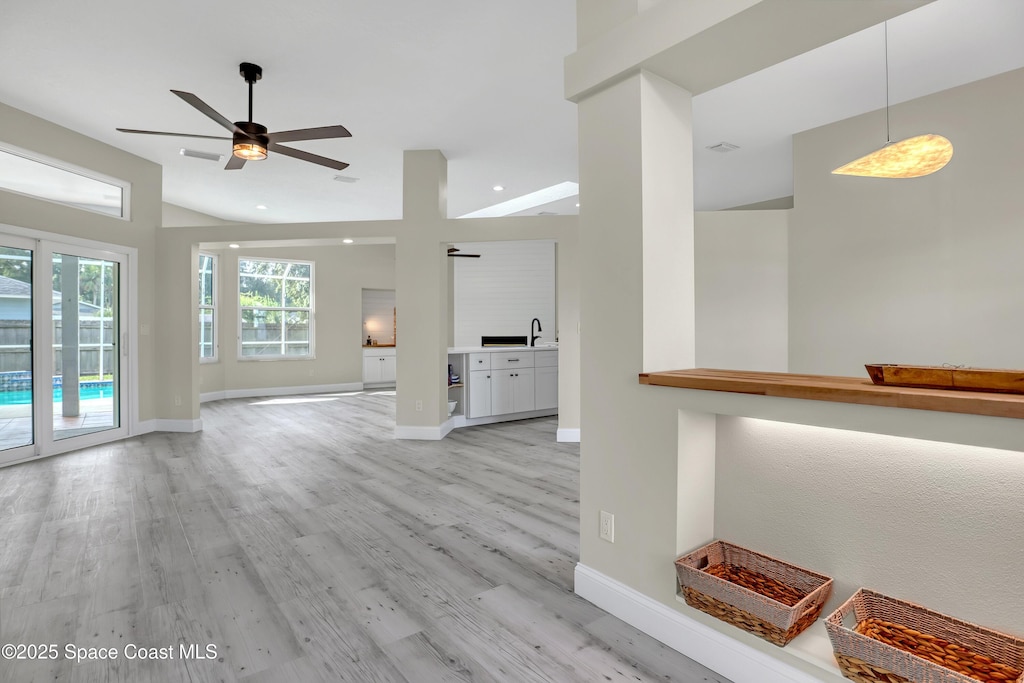 6135 Balboa St, Cocoa, FL 32927 - unfurnished living room featuring light wood-style flooring, ceiling fan, and recessed lighting
