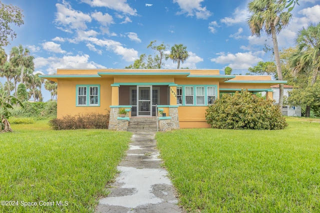1632 Water Dr NE, Palm Bay, FL 32905 - view of front facade with stucco siding and a front lawn