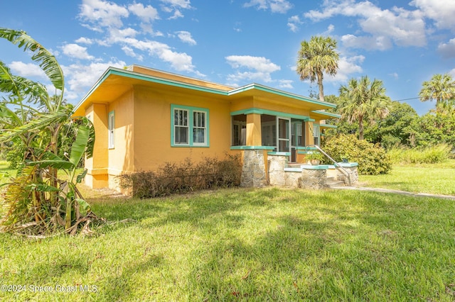 1632 Water Dr NE, Palm Bay, FL 32905 - view of front of house with stucco siding and a front lawn
