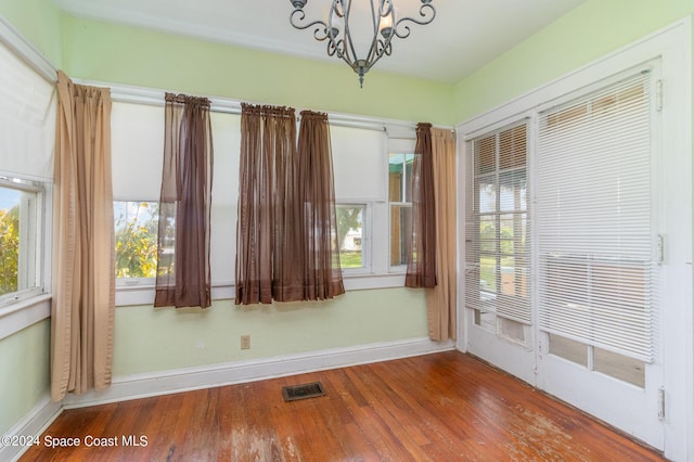 1632 Water Dr NE, Palm Bay, FL 32905 - unfurnished dining area with plenty of natural light, visible vents, wood finished floors, and a chandelier