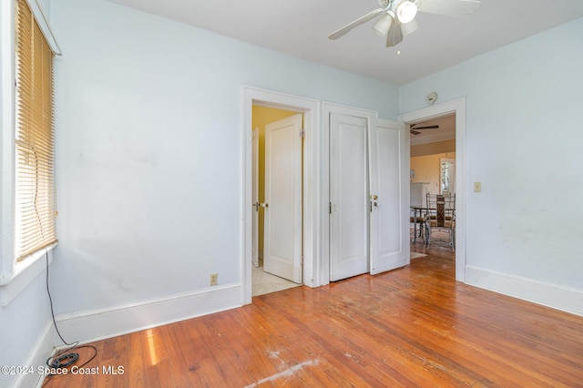 1632 Water Dr NE, Palm Bay, FL 32905 - unfurnished bedroom featuring baseboards, ceiling fan, and wood finished floors