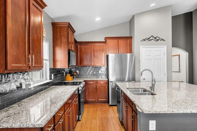 759 Fiddleleaf Cir, Melbourne, FL 32904 - kitchen with appliances with stainless steel finishes, a sink, light wood-style floors, tasteful backsplash, and lofted ceiling