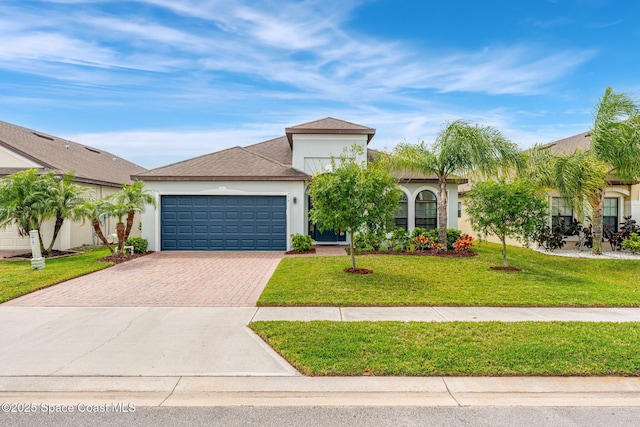 759 Fiddleleaf Cir, Melbourne, FL 32904 - view of front of property featuring decorative driveway, stucco siding, an attached garage, and a front yard