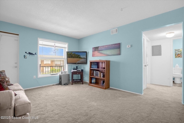 carpeted living room with electric panel, a textured ceiling, baseboards, and visible vents