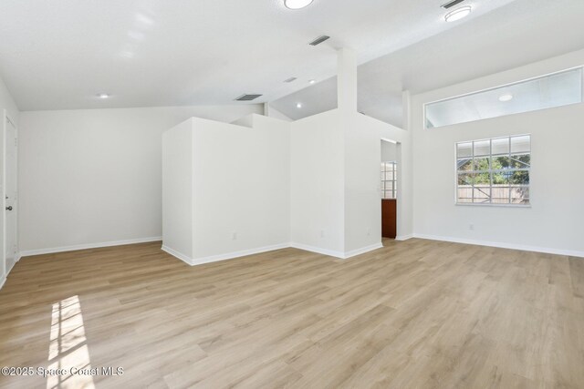 spare room featuring baseboards, visible vents, and light wood-type flooring