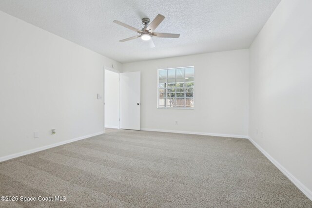 carpeted empty room featuring a ceiling fan, baseboards, and a textured ceiling
