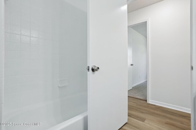 bathroom featuring baseboards and wood finished floors