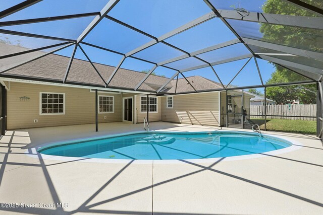 view of pool featuring glass enclosure, fence, a patio, and a fenced in pool