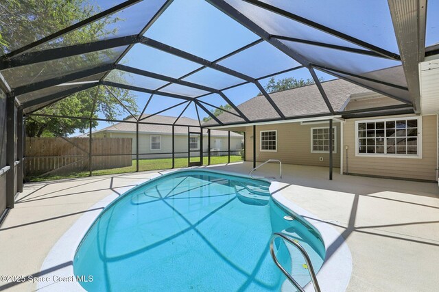 view of swimming pool featuring fence, a lanai, a patio, and a fenced in pool