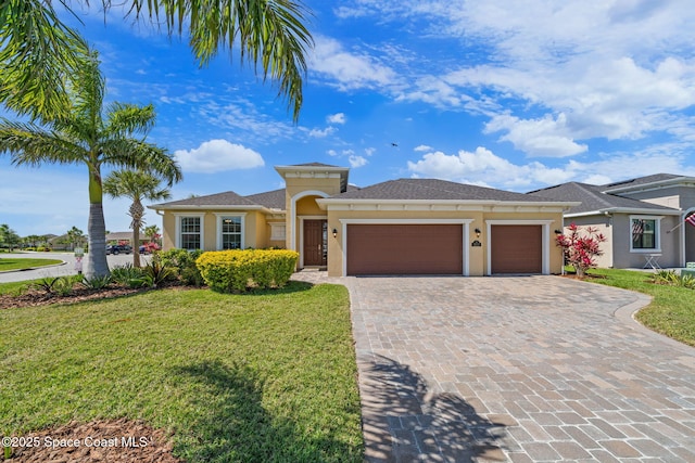 view of front of property with stucco siding, an attached garage, decorative driveway, and a front yard