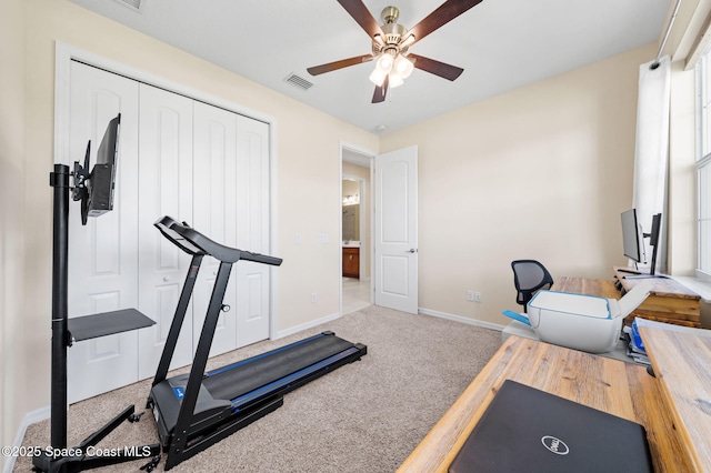 workout room with baseboards, a ceiling fan, and visible vents
