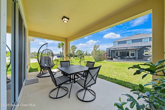 view of patio featuring glass enclosure and outdoor dining area