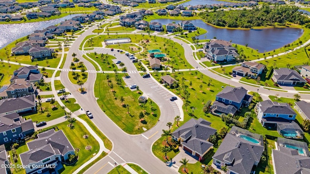 bird's eye view featuring a residential view and a water view