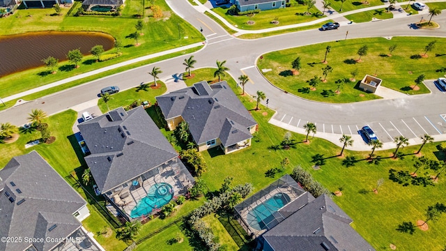 drone / aerial view with a residential view and a water view