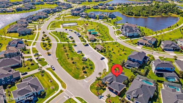 drone / aerial view featuring a water view and a residential view