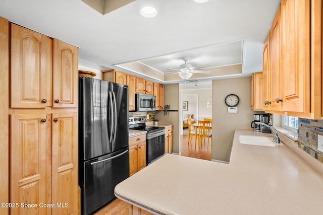 1445 Centaurus Ct, Merritt Island, FL 32953 - kitchen with appliances with stainless steel finishes, a raised ceiling, a sink, tasteful backsplash, and ceiling fan