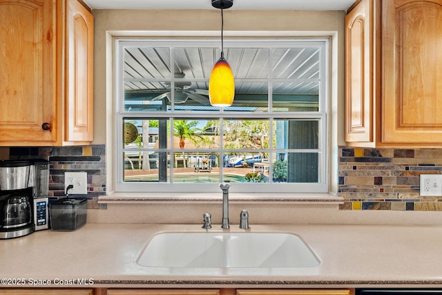 1445 Centaurus Ct, Merritt Island, FL 32953 - kitchen with a sink, decorative backsplash, light countertops, and healthy amount of natural light