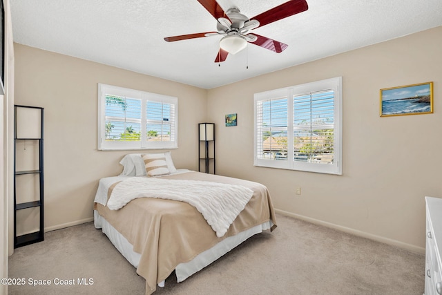 1445 Centaurus Ct, Merritt Island, FL 32953 - bedroom with multiple windows, baseboards, light colored carpet, and a textured ceiling