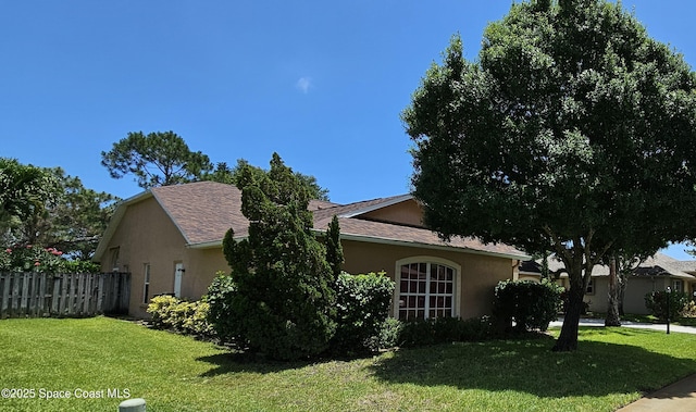 3033 Forest Creek Dr, Melbourne, FL 32901 - view of side of home featuring stucco siding and roof with shingles