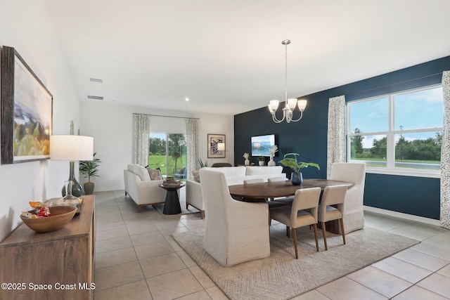 3175 Viridian Cir, Melbourne, FL 32904 - dining space featuring an inviting chandelier, light tile patterned floors, and plenty of natural light