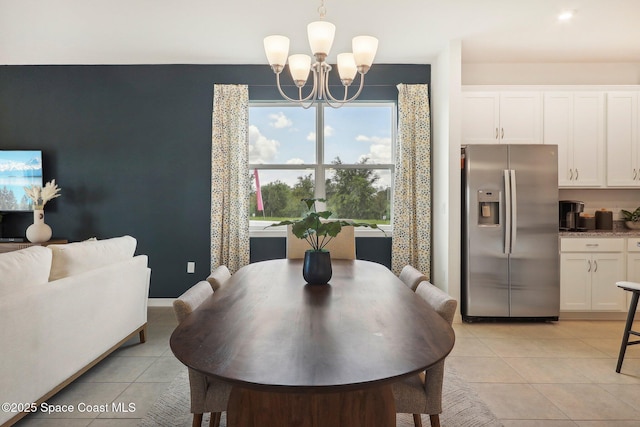 3175 Viridian Cir, Melbourne, FL 32904 - dining room with light tile patterned flooring, baseboards, and a notable chandelier