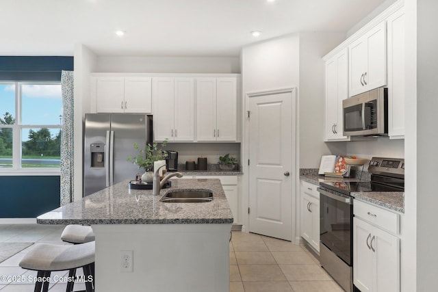 3175 Viridian Cir, Melbourne, FL 32904 - kitchen featuring white cabinetry, a sink, appliances with stainless steel finishes, and an island with sink