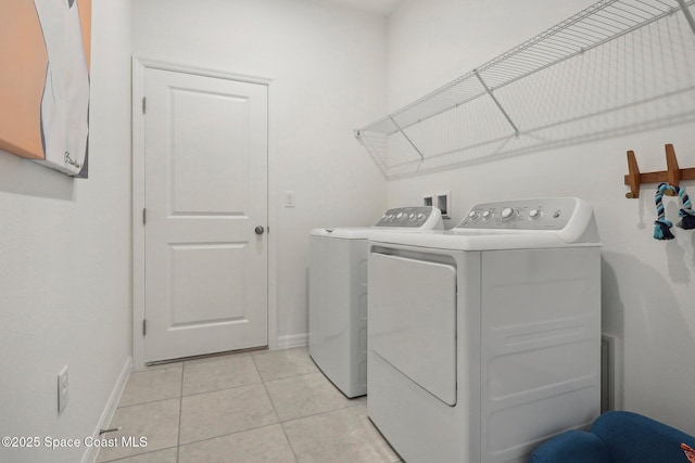 3175 Viridian Cir, Melbourne, FL 32904 - laundry area featuring light tile patterned floors, baseboards, washer and dryer, and laundry area