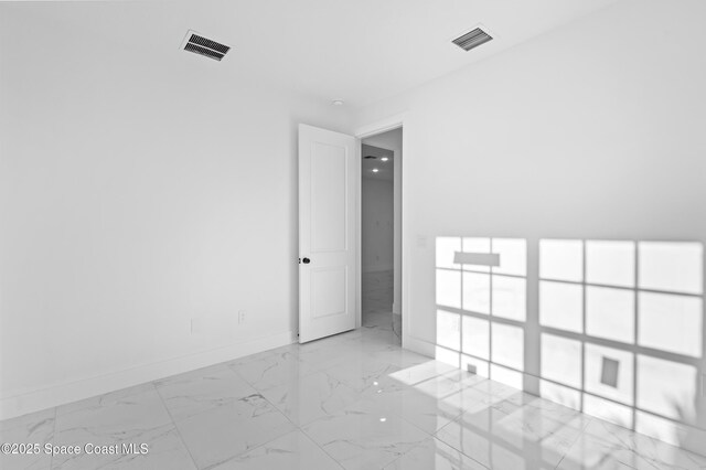 5271 NW Mayfield Ln, Port St Lucie, FL 34983 - spare room featuring marble finish floor, baseboards, and visible vents