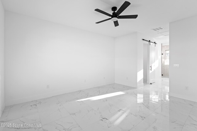 5271 NW Mayfield Ln, Port St Lucie, FL 34983 - unfurnished room with a ceiling fan, a barn door, marble finish floor, baseboards, and visible vents